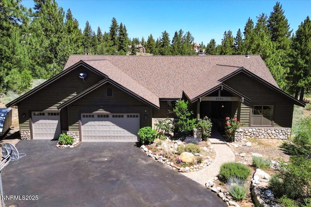 6195 Philoree Ln, Reno, NV 89511 - view of front of home with stone siding, driveway, and an attached garage