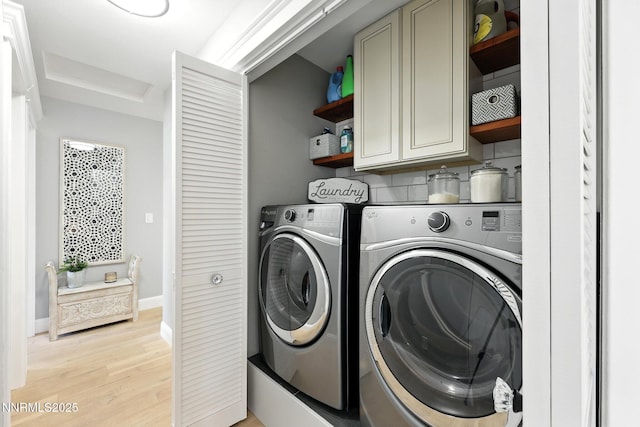 5863 Foggy Ct, Sun Valley, NV 89433 - laundry area with cabinet space, washing machine and dryer, light wood-style floors, and attic access