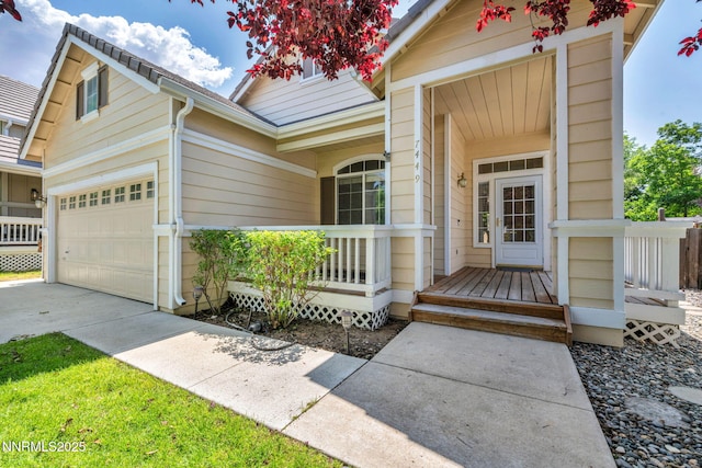 7449 Ambush Cir, Sparks, NV 89436 - property entrance with concrete driveway, a garage, and covered porch