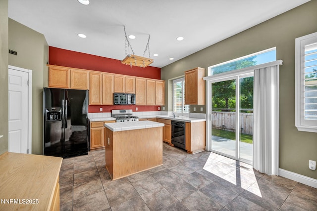 7449 Ambush Cir, Sparks, NV 89436 - kitchen with black appliances, a kitchen island, tile countertops, light brown cabinets, and recessed lighting