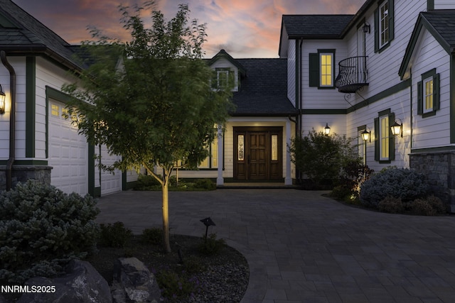 6145 Triple Crown Dr, Reno, NV 89511 - property entrance with an attached garage, driveway, and roof with shingles