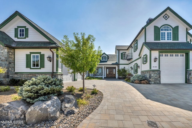 6145 Triple Crown Dr, Reno, NV 89511 - view of front of property featuring stone siding, decorative driveway, and an attached garage