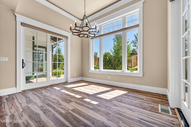 6145 Triple Crown Dr, Reno, NV 89511 - unfurnished dining area featuring a chandelier, wood finished floors, and ornamental molding