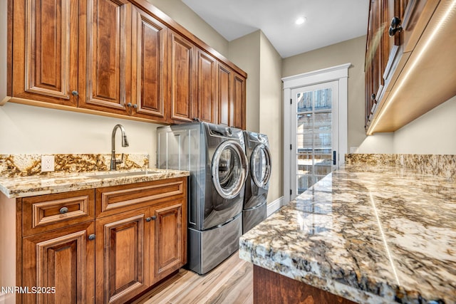 6145 Triple Crown Dr, Reno, NV 89511 - laundry area featuring washing machine and dryer, cabinet space, light wood finished floors, and recessed lighting