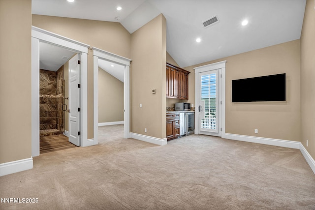 6145 Triple Crown Dr, Reno, NV 89511 - unfurnished living room with lofted ceiling, light colored carpet, wine cooler, and recessed lighting
