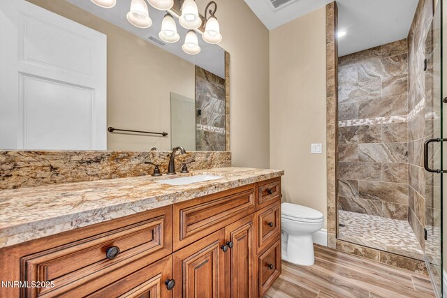 6145 Triple Crown Dr, Reno, NV 89511 - bathroom with a stall shower, vanity, and wood finished floors