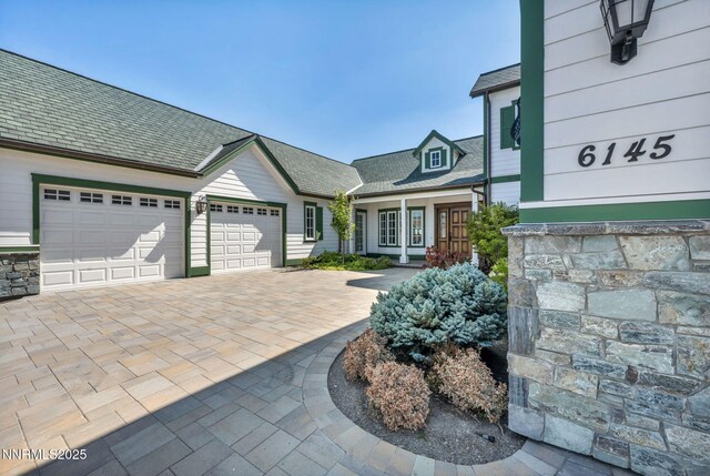 6145 Triple Crown Dr, Reno, NV 89511 - view of front of home with a garage, driveway, and stone siding
