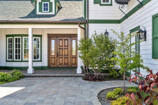 6145 Triple Crown Dr, Reno, NV 89511 - doorway to property featuring a porch and roof with shingles