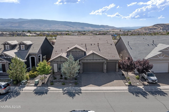 9435 Stony Hill Rd, Reno, NV 89521 - view of front of house featuring a garage, driveway, a residential view, and a mountain view