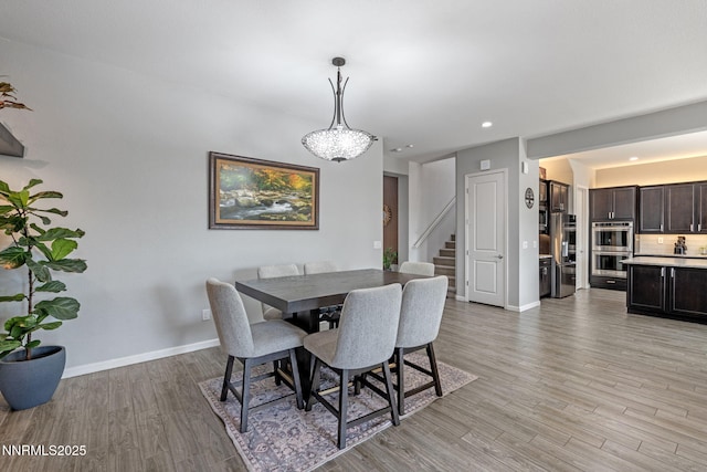 9435 Stony Hill Rd, Reno, NV 89521 - dining area featuring stairway, light wood-style floors, and recessed lighting
