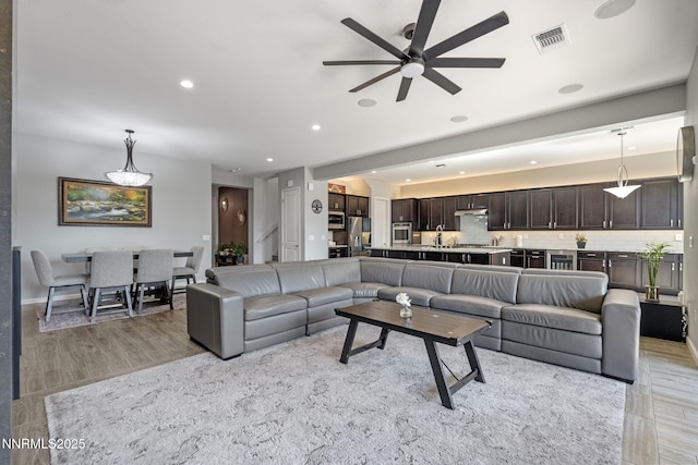 9435 Stony Hill Rd, Reno, NV 89521 - living area featuring light wood-style flooring, a ceiling fan, recessed lighting, and beverage cooler