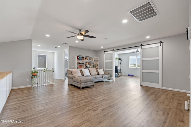 9435 Stony Hill Rd, Reno, NV 89521 - living area featuring a barn door, ceiling fan, light wood-style floors, and recessed lighting