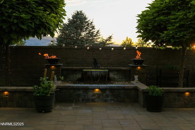 9435 Stony Hill Rd, Reno, NV 89521 - patio terrace at dusk with a patio area and a fenced backyard