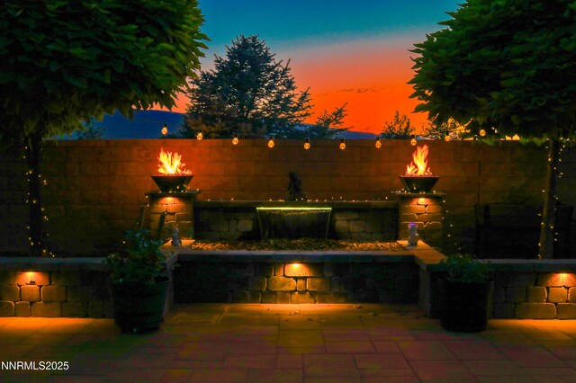 9435 Stony Hill Rd, Reno, NV 89521 - fenced backyard featuring a fire pit and a patio area
