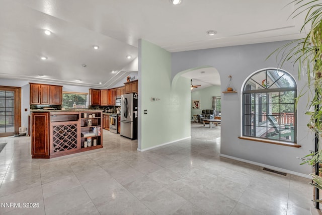 3279 Upland Ct, Carson City, NV 89703 - kitchen featuring stainless steel appliances, arched walkways, vaulted ceiling, open shelves, and recessed lighting