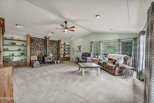 3279 Upland Ct, Carson City, NV 89703 - living area with a wood stove, lofted ceiling, carpet floors, and a ceiling fan