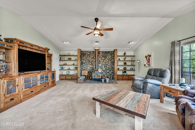 3279 Upland Ct, Carson City, NV 89703 - carpeted living room featuring lofted ceiling, a ceiling fan, a wood stove, and built in features