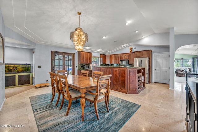 3279 Upland Ct, Carson City, NV 89703 - dining space featuring lofted ceiling, arched walkways, plenty of natural light, a chandelier, and light tile patterned floors