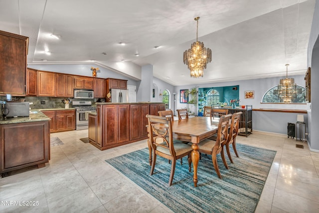 3279 Upland Ct, Carson City, NV 89703 - dining room featuring a chandelier, vaulted ceiling, and light tile patterned floors