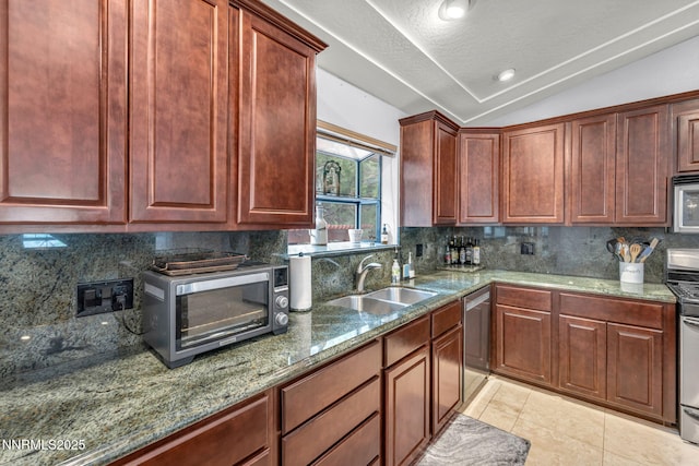 3279 Upland Ct, Carson City, NV 89703 - kitchen with vaulted ceiling, stainless steel appliances, stone counters, decorative backsplash, and light tile patterned floors