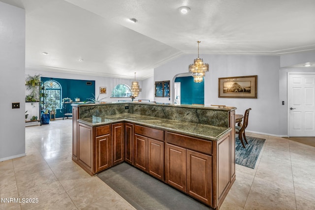 3279 Upland Ct, Carson City, NV 89703 - kitchen featuring a chandelier, hanging light fixtures, light tile patterned floors, lofted ceiling, and dark stone counters