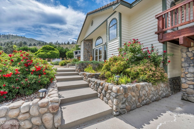 3279 Upland Ct, Carson City, NV 89703 - view of exterior entry with a mountain view and stone siding