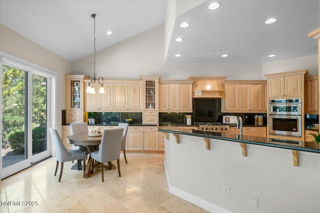 4990 Mountainshyre Rd, Reno, NV 89519 - kitchen featuring stainless steel double oven, a kitchen breakfast bar, tasteful backsplash, premium range hood, and glass insert cabinets