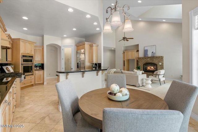 4990 Mountainshyre Rd, Reno, NV 89519 - dining area featuring recessed lighting, a high ceiling, ceiling fan, a fireplace, and light tile patterned flooring