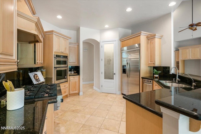 4990 Mountainshyre Rd, Reno, NV 89519 - kitchen featuring appliances with stainless steel finishes, light brown cabinetry, a ceiling fan, arched walkways, and recessed lighting