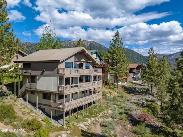 1459 Glarus Ct, Incline Village, NV 89451 - rear view of property with a balcony, a mountain view, and a metal roof