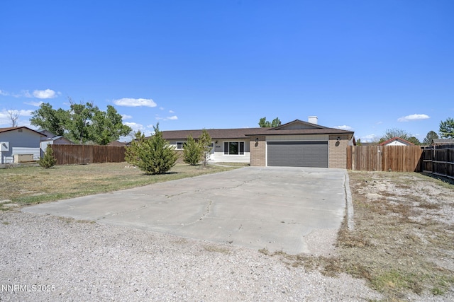 684 Carson River Dr, Fallon, NV 89406 - ranch-style home featuring brick siding, concrete driveway, a garage, and a chimney