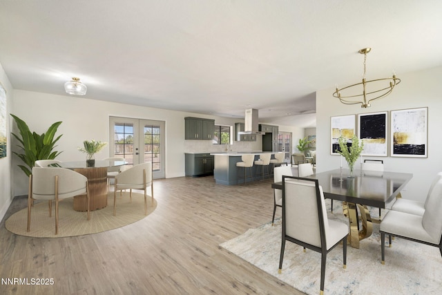 684 Carson River Dr, Fallon, NV 89406 - dining room with light wood-style flooring, a chandelier, and french doors