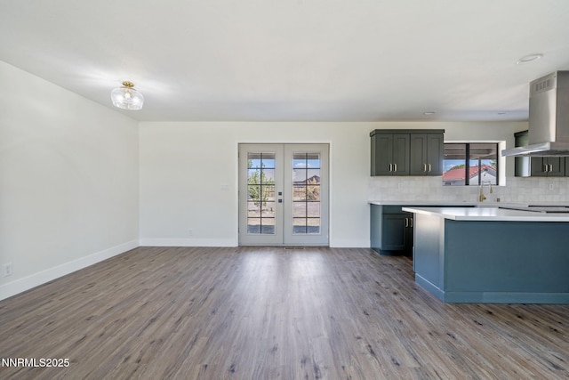684 Carson River Dr, Fallon, NV 89406 - kitchen featuring island range hood, light countertops, backsplash, wood finished floors, and french doors