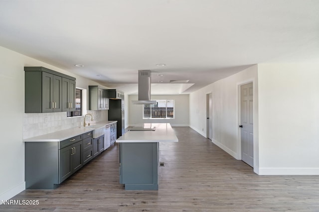 684 Carson River Dr, Fallon, NV 89406 - kitchen featuring island range hood, light wood-style flooring, light countertops, gray cabinets, and stovetop