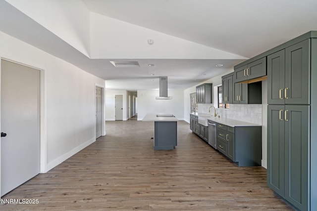 684 Carson River Dr, Fallon, NV 89406 - kitchen featuring wall chimney range hood, stainless steel dishwasher, vaulted ceiling, wood finished floors, and light countertops