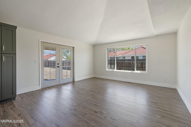 684 Carson River Dr, Fallon, NV 89406 - empty room with french doors, wood finished floors, and vaulted ceiling