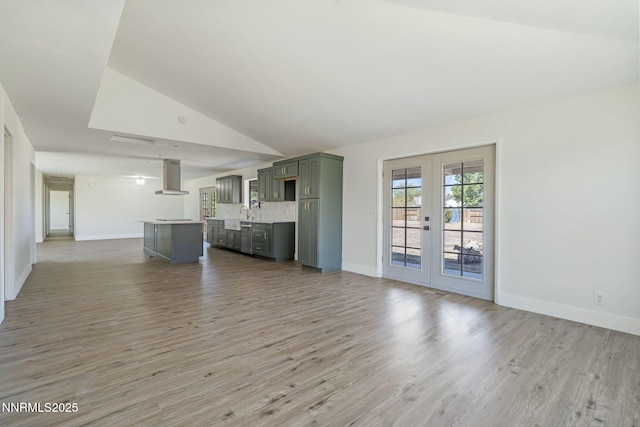 684 Carson River Dr, Fallon, NV 89406 - unfurnished living room featuring french doors, lofted ceiling, and light wood-style floors
