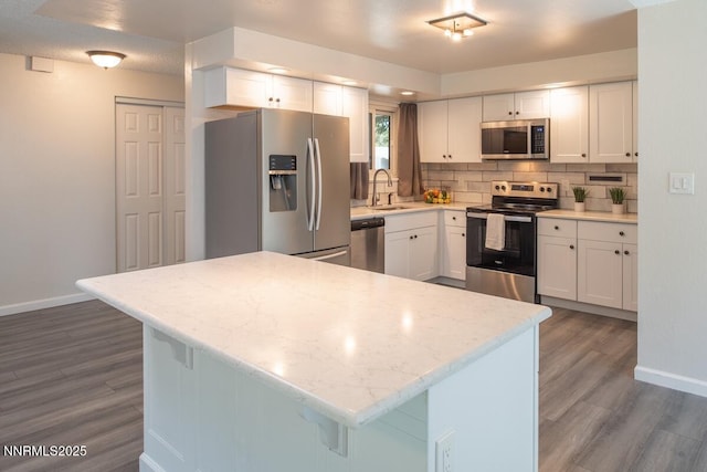 875 Camino Real Dr, Sparks, NV 89434 - kitchen featuring stainless steel appliances, wood finished floors, backsplash, and white cabinetry