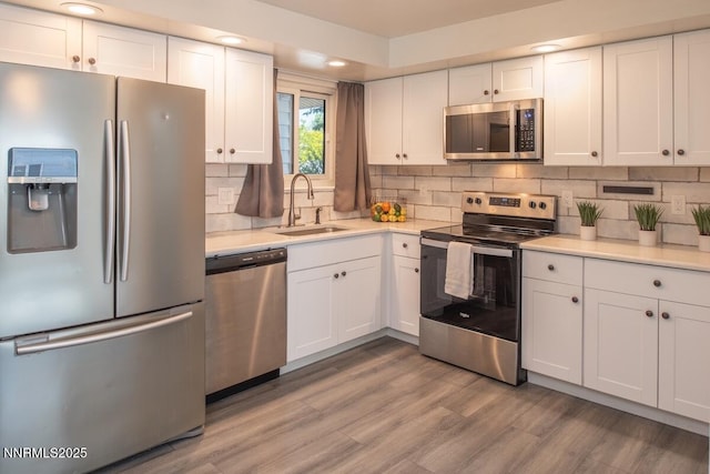 875 Camino Real Dr, Sparks, NV 89434 - kitchen with appliances with stainless steel finishes, white cabinets, light countertops, backsplash, and recessed lighting