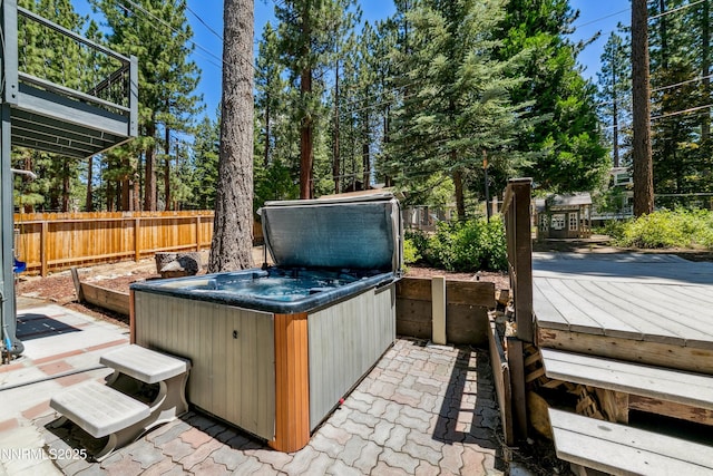 299 Chimney Rock Rd, Stateline, NV 89449 - fenced backyard with a hot tub, a wooden deck, and view of scattered trees