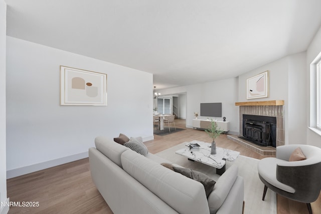 1305 Gault Way, Sparks, NV 89431 - living area with light wood-style flooring, a chandelier, a tile fireplace, and plenty of natural light