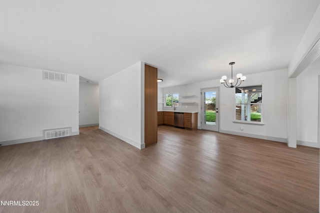 1305 Gault Way, Sparks, NV 89431 - unfurnished living room with a chandelier and light wood-style flooring