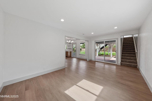 1305 Gault Way, Sparks, NV 89431 - unfurnished living room with a chandelier, light wood finished floors, stairs, and recessed lighting