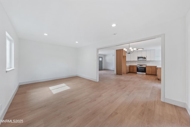 1305 Gault Way, Sparks, NV 89431 - unfurnished living room with a chandelier, light wood finished floors, and recessed lighting