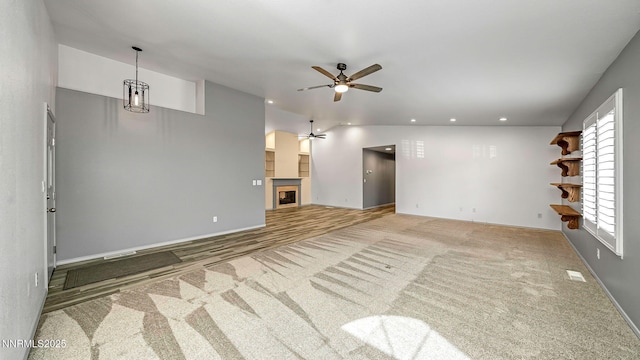 2015 Flycatcher Dr, Spanish Springs, NV 89441 - unfurnished living room featuring a fireplace, a ceiling fan, recessed lighting, and carpet floors