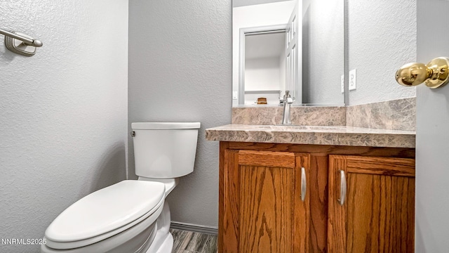 2015 Flycatcher Dr, Spanish Springs, NV 89441 - half bathroom featuring a textured wall, vanity, and wood finished floors