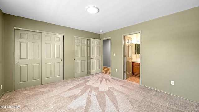 2015 Flycatcher Dr, Spanish Springs, NV 89441 - unfurnished bedroom featuring light carpet, multiple closets, and connected bathroom