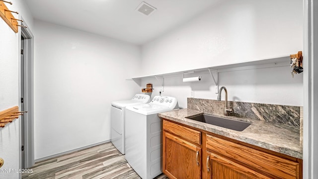 2015 Flycatcher Dr, Spanish Springs, NV 89441 - laundry room with separate washer and dryer, light wood-style flooring, and cabinet space