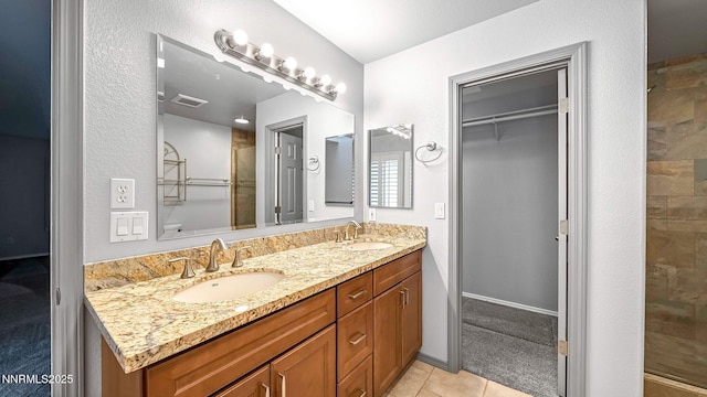 2015 Flycatcher Dr, Spanish Springs, NV 89441 - bathroom featuring double vanity, a stall shower, tile patterned floors, and a walk in closet