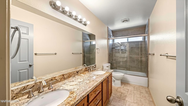 2015 Flycatcher Dr, Spanish Springs, NV 89441 - bathroom featuring double vanity, enclosed tub / shower combo, and stone finish floors